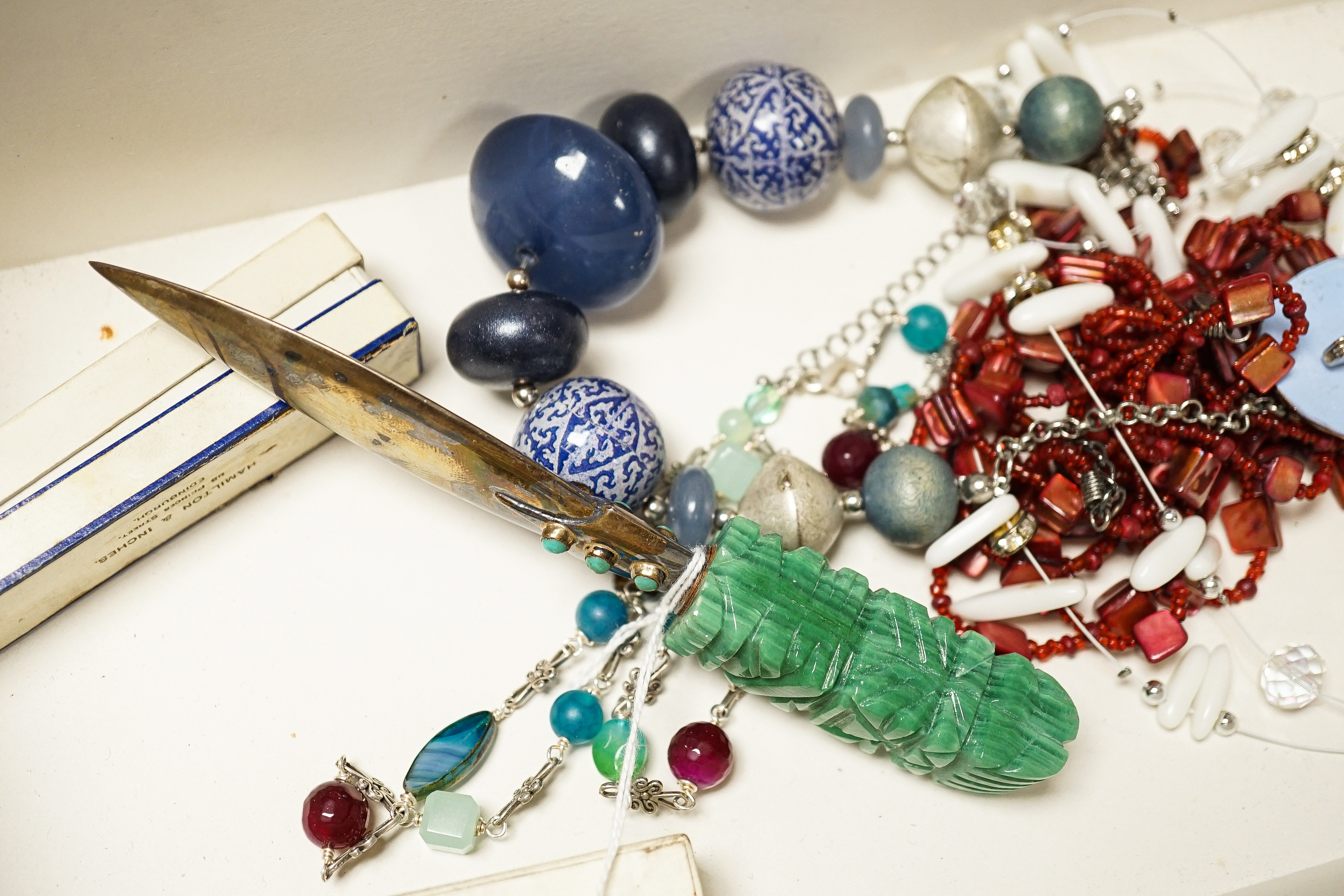 Two silver mounted hardstone Claymore sword shaped bookmarks, a white metal and hardstone paper knife and a quantity of costume jewellery.
